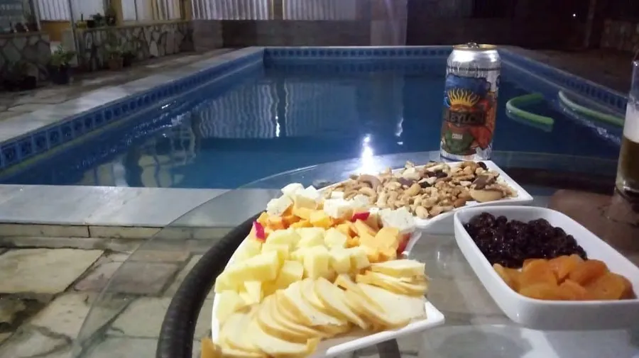 Petiscos servidos à beira da piscina à noite